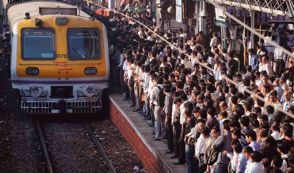 Railway officials reviewing newly designed coach for Mumbai suburban rail network.