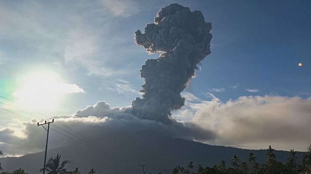 Mount Lewotobi erupting with a massive ash cloud over nearby villages.