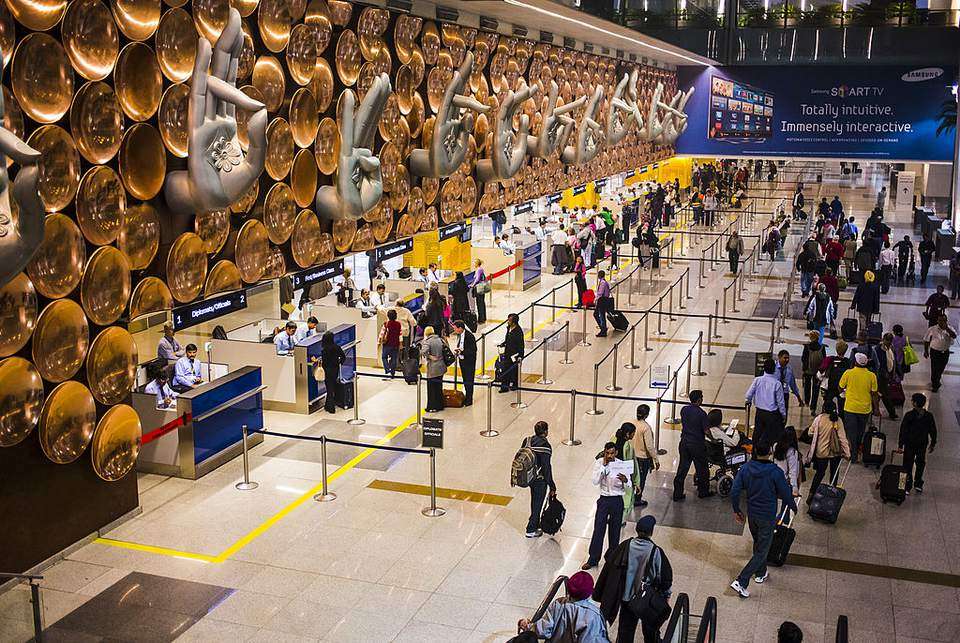 Indian airport terminal with busy passengers and aircraft, highlighting growth in the domestic aviation market.