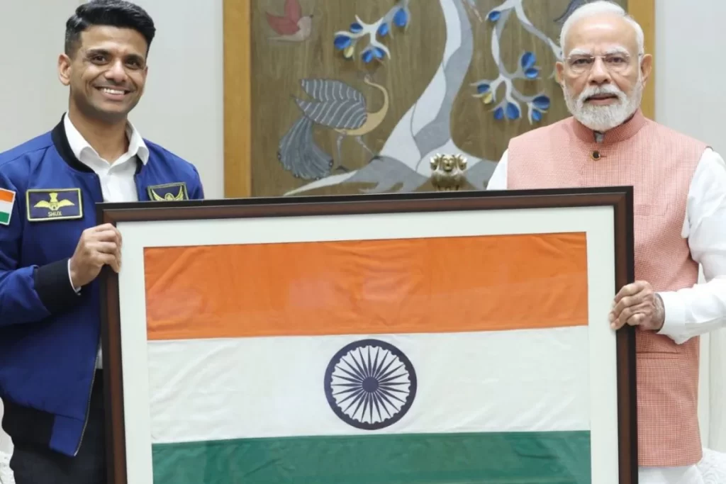 Astronaut gifts flag to Modi