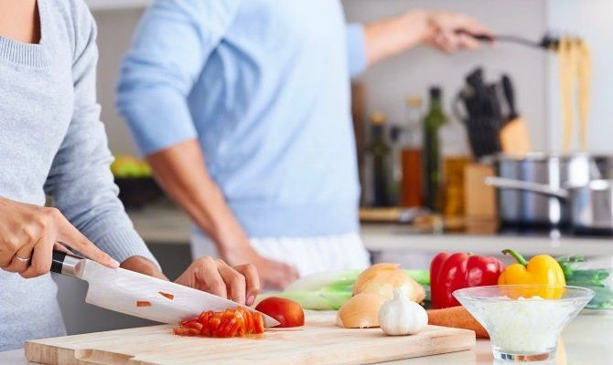 Family cooking fresh meal in modern kitchen.