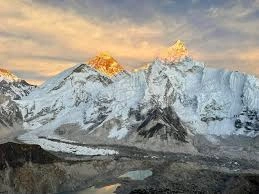 Snow‑covered Himalayan peaks under blue sky.
