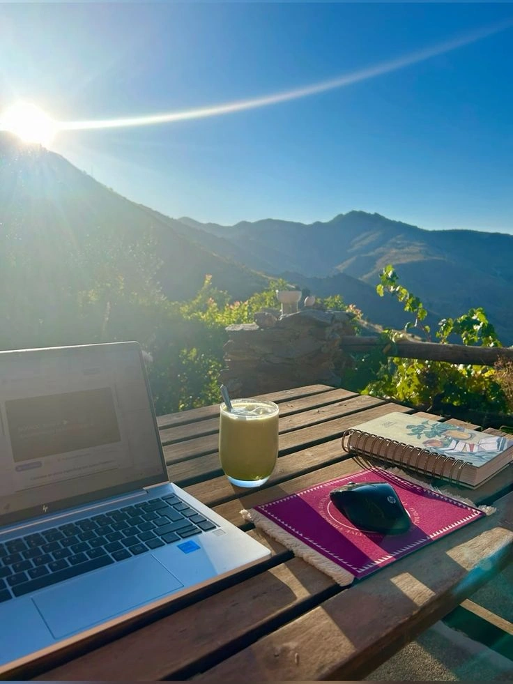 Digital nomads working in scenic hill cafe.