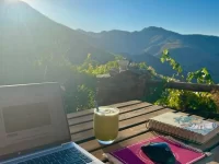 Digital nomads working in scenic hill cafe.